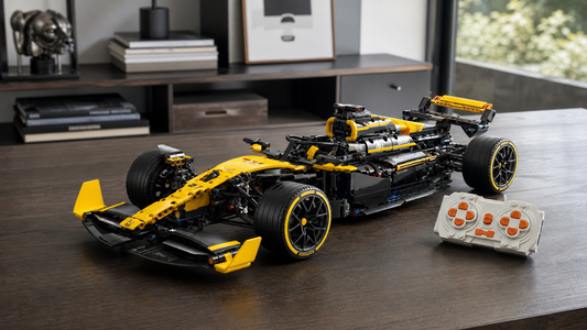 Yellow and black 1:8 Formula RC building block car on an adult collector table with white orange-button remote controller
